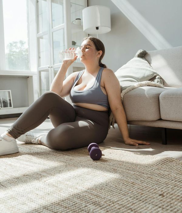 A neat setup for home exercise with a yoga mat, water bottle, and comfortable clothes.