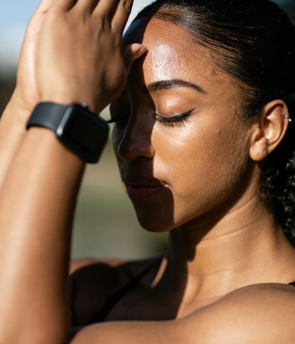 Person in a calm meditative state outdoors, surrounded by nature.